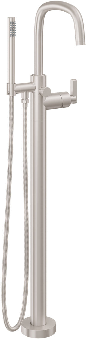 Polished brass floor-mount tub filler with curved spout, hand shower, and flexible hose.