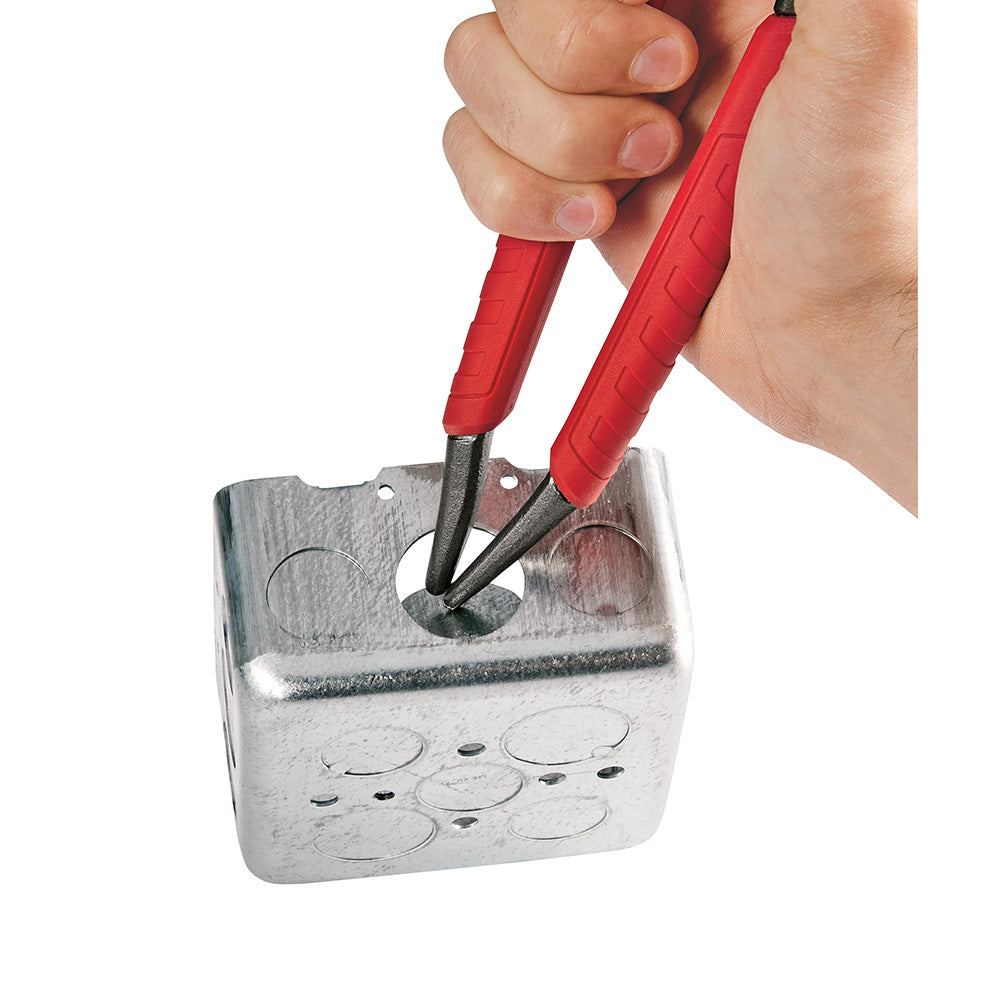 Hex-jaw pliers with red handles being held above a metal electrical box.