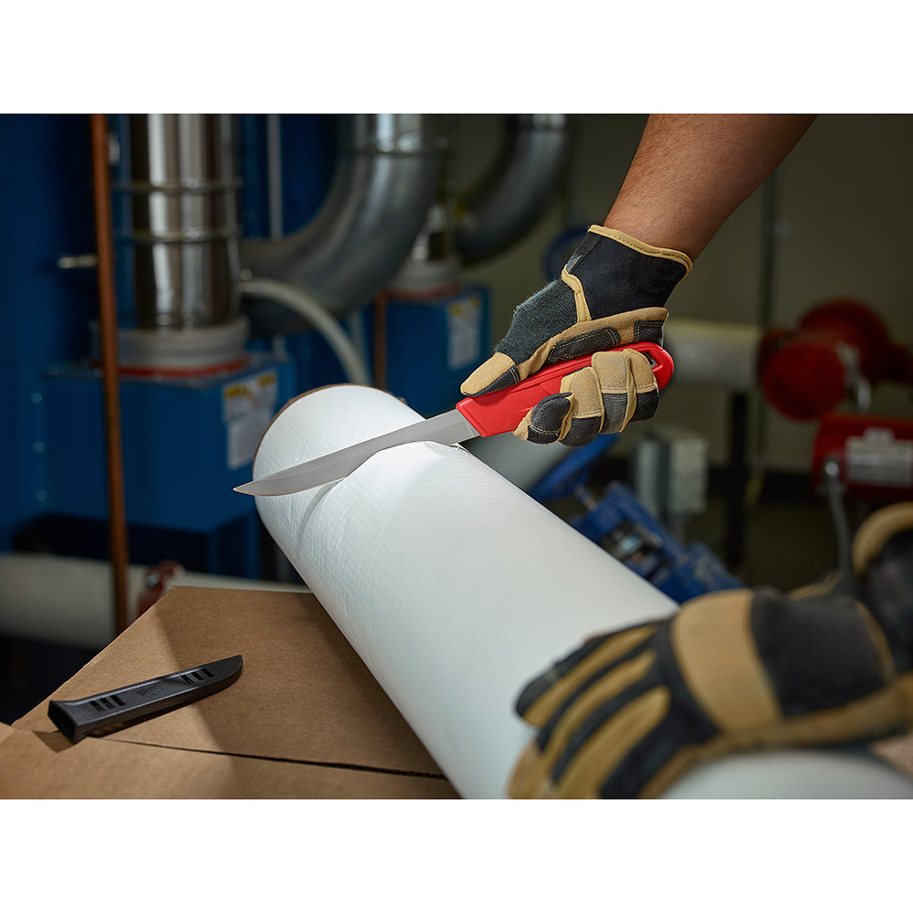 Straight edge insulation knife with red handle and silver blade cutting white insulation material, held in gloved hands.