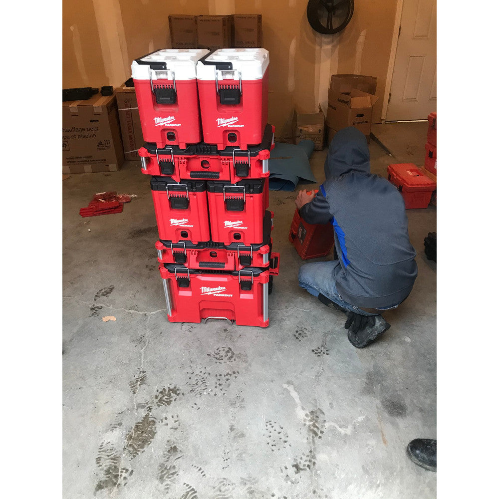Red Milwaukee PACKOUT coolers stacked vertically with black handles and latches, displaying compact design.