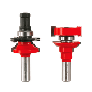 Two Freud router bits with red cutting heads and steel shanks, shown from front and side angles with adjustable components.