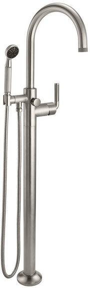 Burnished brass floor-mount tub filler with curved arc spout, hand shower, and lever controls.