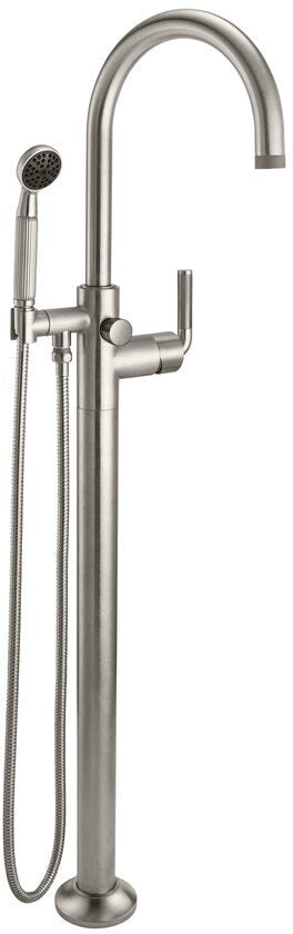 Burnished brass floor-mount tub filler with curved arc spout, hand shower, and lever controls.