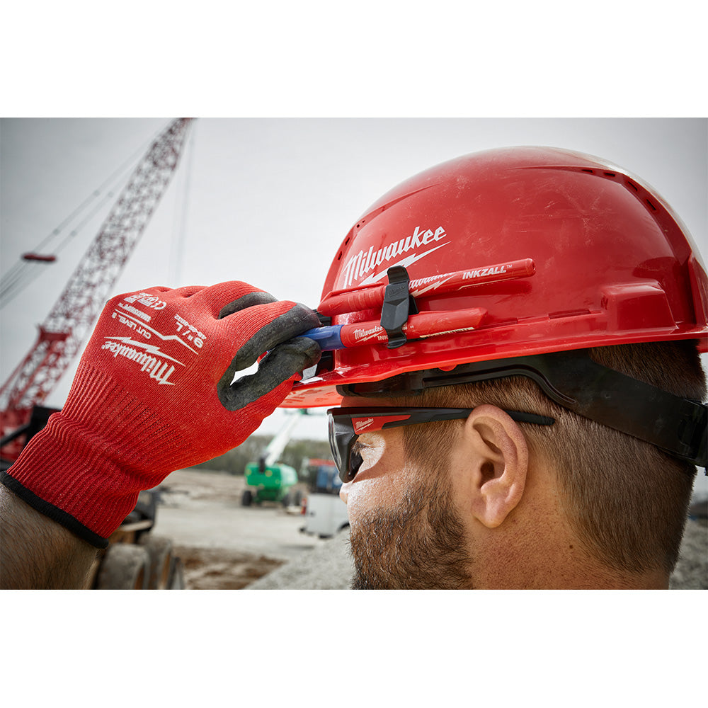 Black hard hat with front brim, vented crown, and ratcheting suspension system visible on wearer's head.