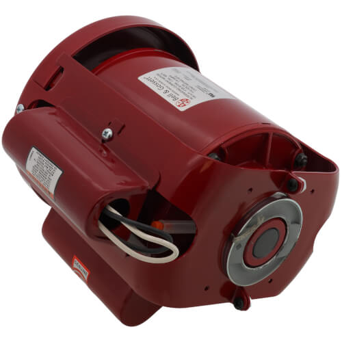 Red cylindrical electric motor with label plate, mounting brackets, and power cord on dark background.