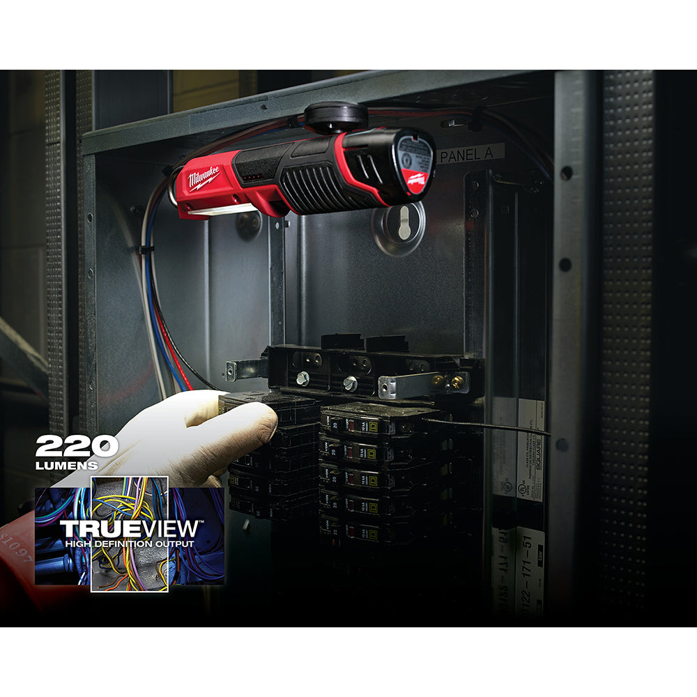 Milwaukee M12 red and black LED stick light mounted in electrical panel with 220 lumens output.