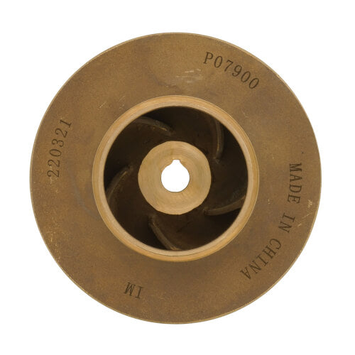 Brass pump impeller with curved internal blades, center hole, and curved text markings on outer surface.
