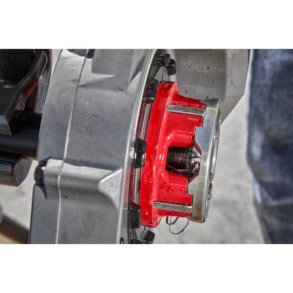 Red and silver Milwaukee pipe threading die head with NPT markings mounted on equipment.