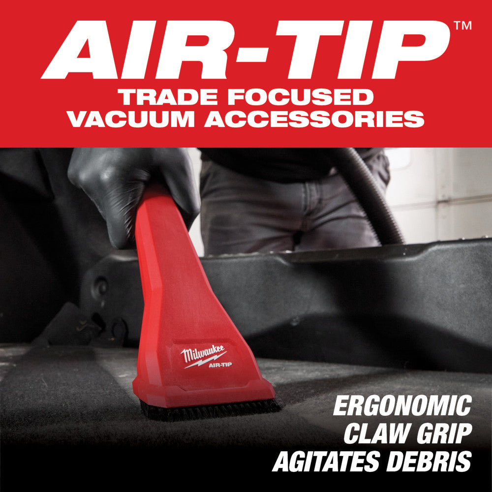 Red and black Milwaukee AIR-TIP claw nozzle with brush bristles attached to vacuum hose.