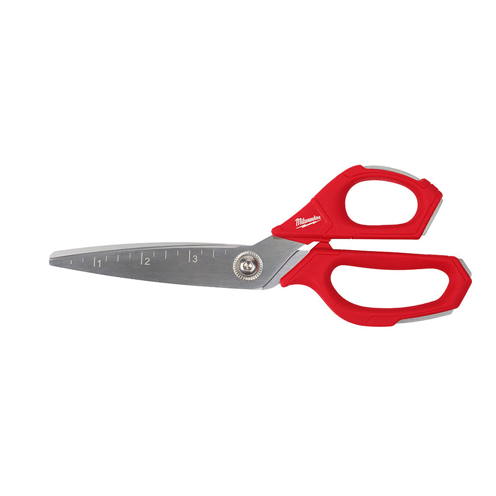 Straight scissors with gray metal blade marked with ruler measurements and red handles with oval finger loops.