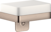 Brushed nickel soap dispenser with white ceramic shelf and soap pump below.