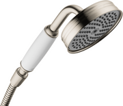 Brushed nickel handheld showerhead with white grip, round perforated face, and flexible hose attached.