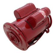 Red cylindrical electric motor with dual shaft openings and mounting feet, viewed from angled side perspective.