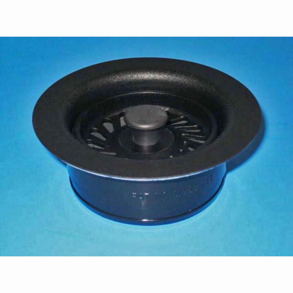Matte black circular fixture with recessed center dome and fan-like vanes on blue background.