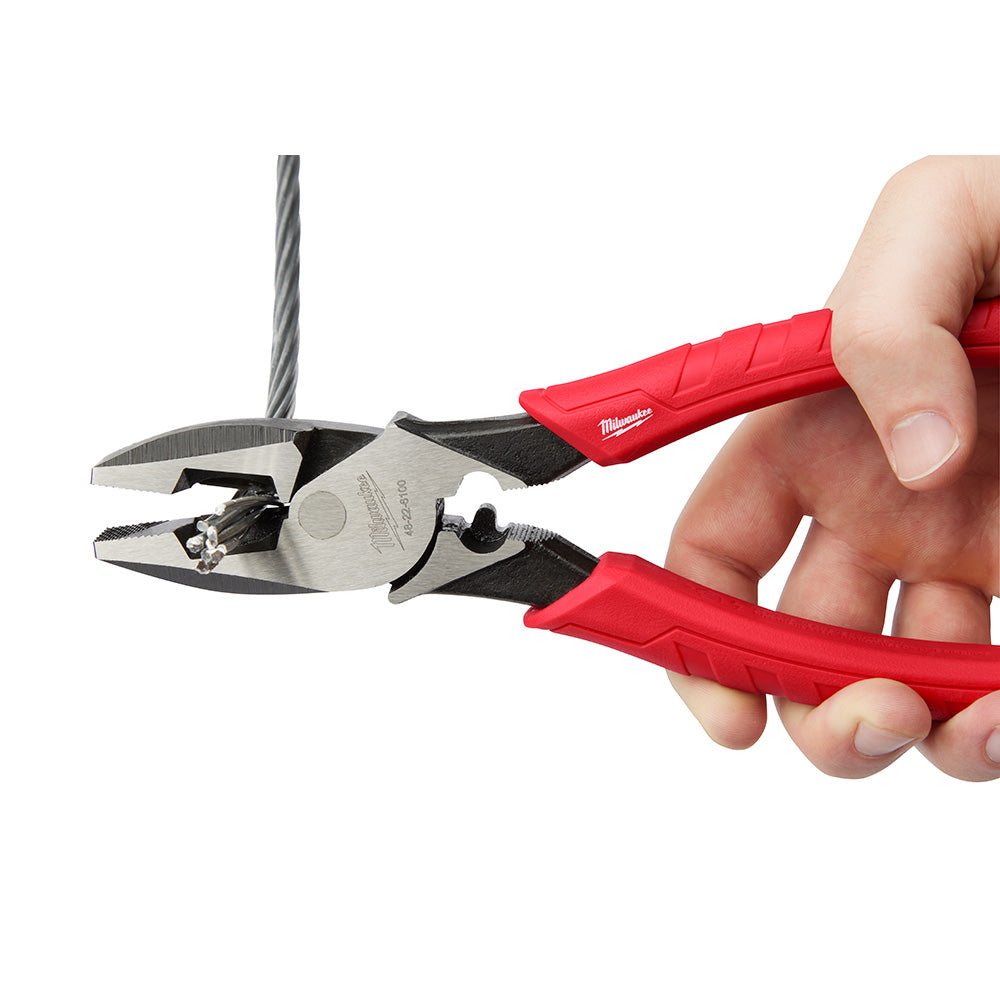 Milwaukee lineman's pliers with red and black handles held in hand, showing metal jaws and crimper feature.