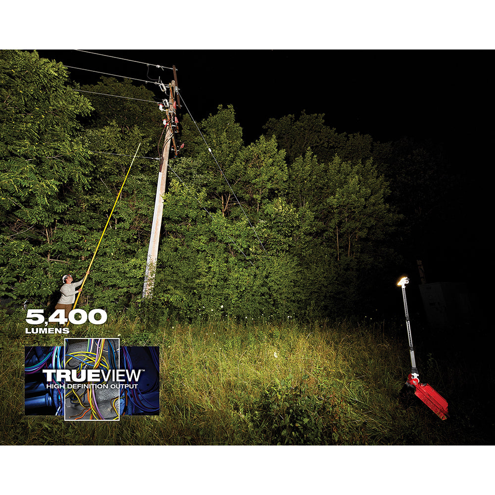 Two tall LED work lights illuminating an outdoor wooded area at night, one mounted on a pole and one on a red stand.