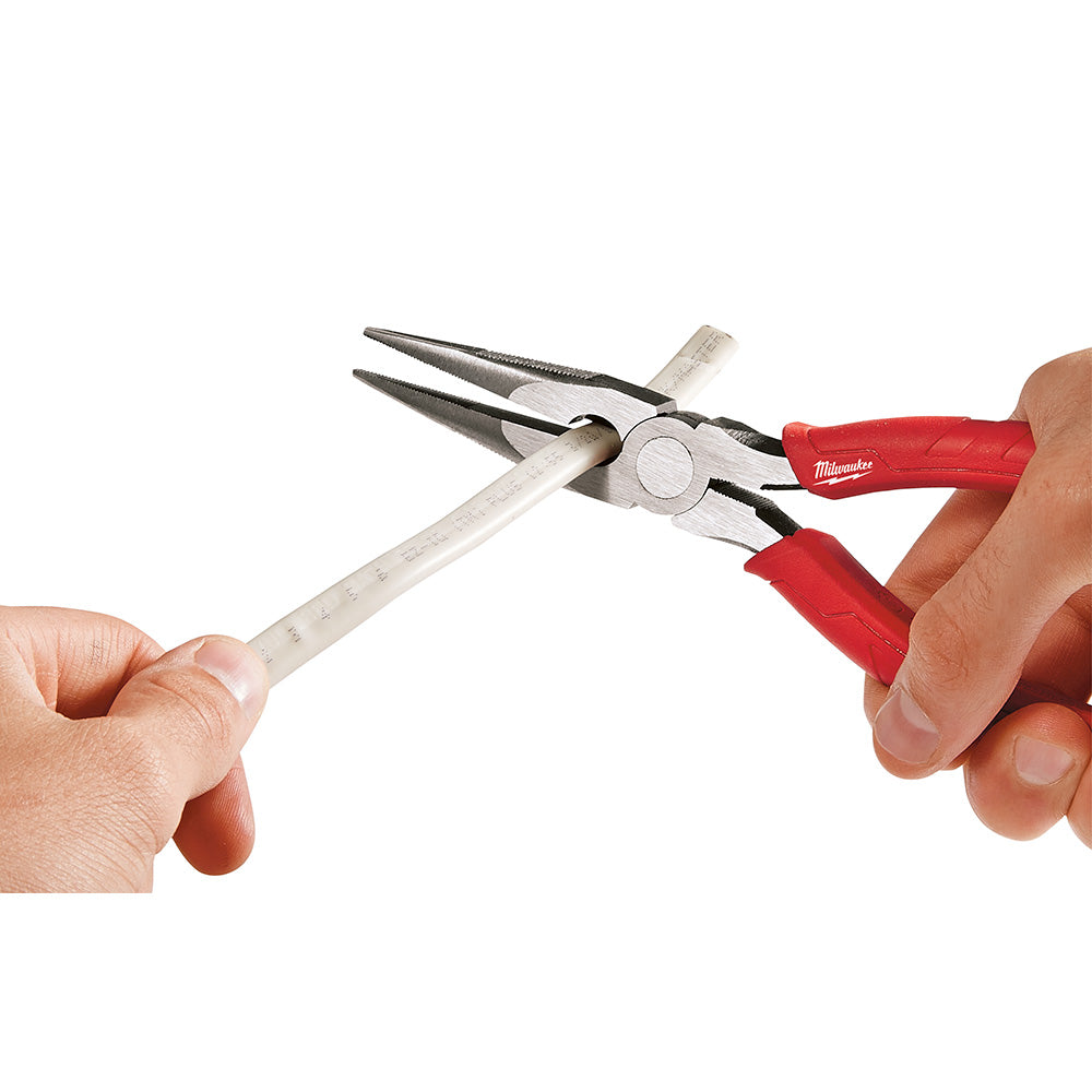 Milwaukee long nose pliers with red handles and metal jaws held in hands showing measurement scale.