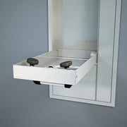 Stainless steel recess-mounted eyewash station with swing-down basin and two brown foot pedal controls.