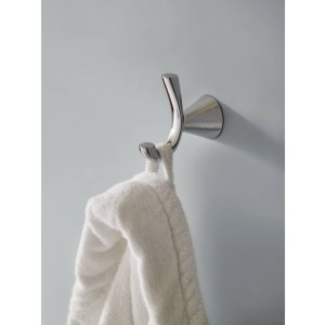 Brushed nickel wall-mount robe hook with curved arm holding a white towel.