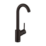 Matte black bar faucet with curved spout and single lever handle on cylindrical base.
