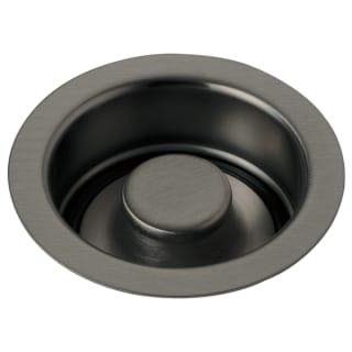 Chrome and black kitchen sink disposal flange stopper with round button control.