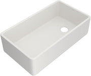 White fireclay farmhouse apron front kitchen sink with single bowl and drain hole.
