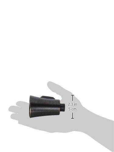 Pull-down spray assembly with black cylindrical body and gray lever handle, shown in hand for scale.