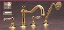 Polished nickel 4-hole deck mount tub filler with curved spout and lever handles.