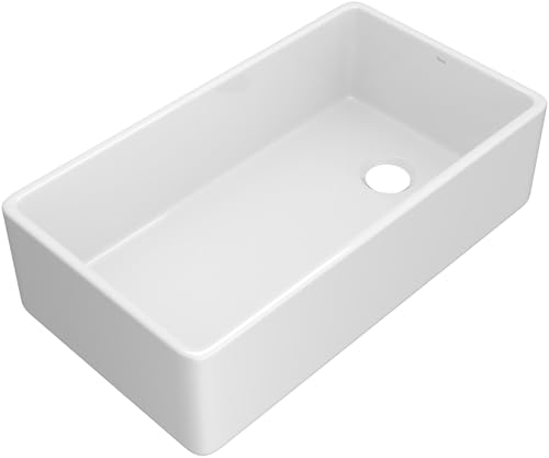 White fireclay farmhouse sink with single rectangular bowl and apron front design.