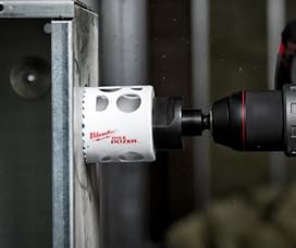 Milwaukee 5-inch bi-metal hole saw with white housing and red branding mounted on metal surface.