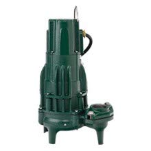 Green submersible sewage pump with vertical ribbed housing, power cord, and attached base feet.