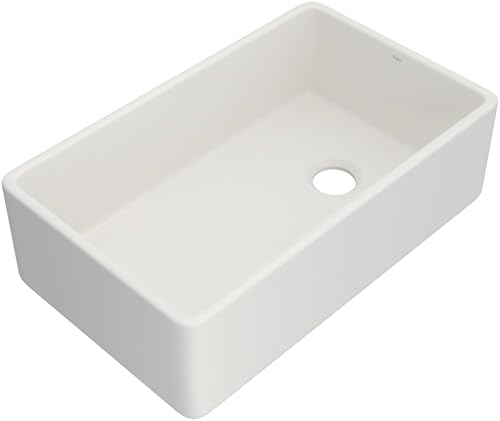 White fireclay single bowl farmhouse apron front kitchen sink with drain hole.