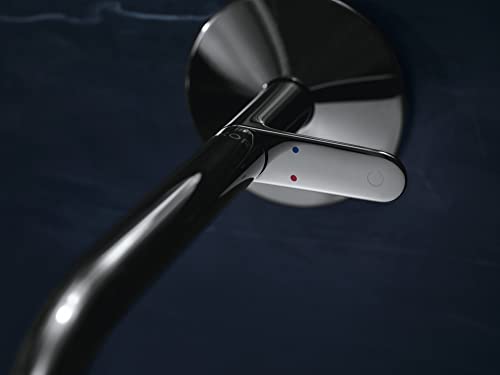 Chrome wall-mounted single-handle faucet with lever handle and circular backplate against dark background.
