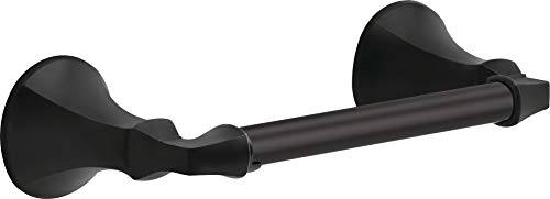 Black metal tissue holder with curved end caps and cylindrical bar mounted horizontally.