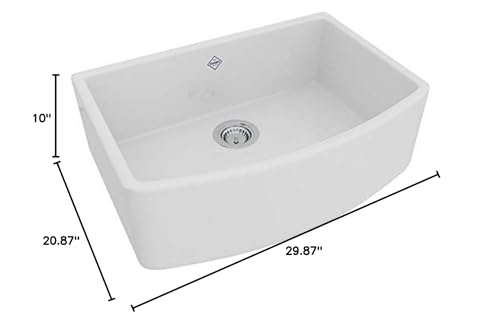 White fireclay farmhouse sink with single bowl, curved apron front, and chrome drain fixture, 30 inches wide.