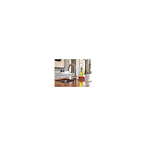 Chrome pull-down kitchen faucet with curved spout installed over sink in countertop.