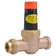 Brass pressure reducing valve with 3/4 inch connections, orange adjustment cap, and yellow instruction label.