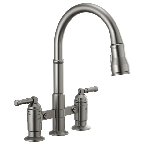 Stainless steel bridge kitchen faucet with two side handles and a curved pull-down sprayer.