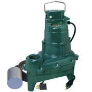 Green cast iron sewage pump with carrying handle, discharge outlet, attached black power cord and switch.