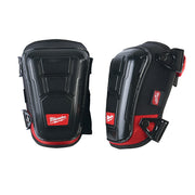 Black and red knee pad with hard plastic shell, red mesh panels, and adjustable straps with Milwaukee branding shown front an
