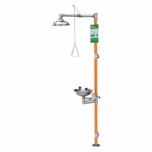 Stainless steel floor-mounted safety station with overhead eyewash and shower heads on orange pole with green instruction lab