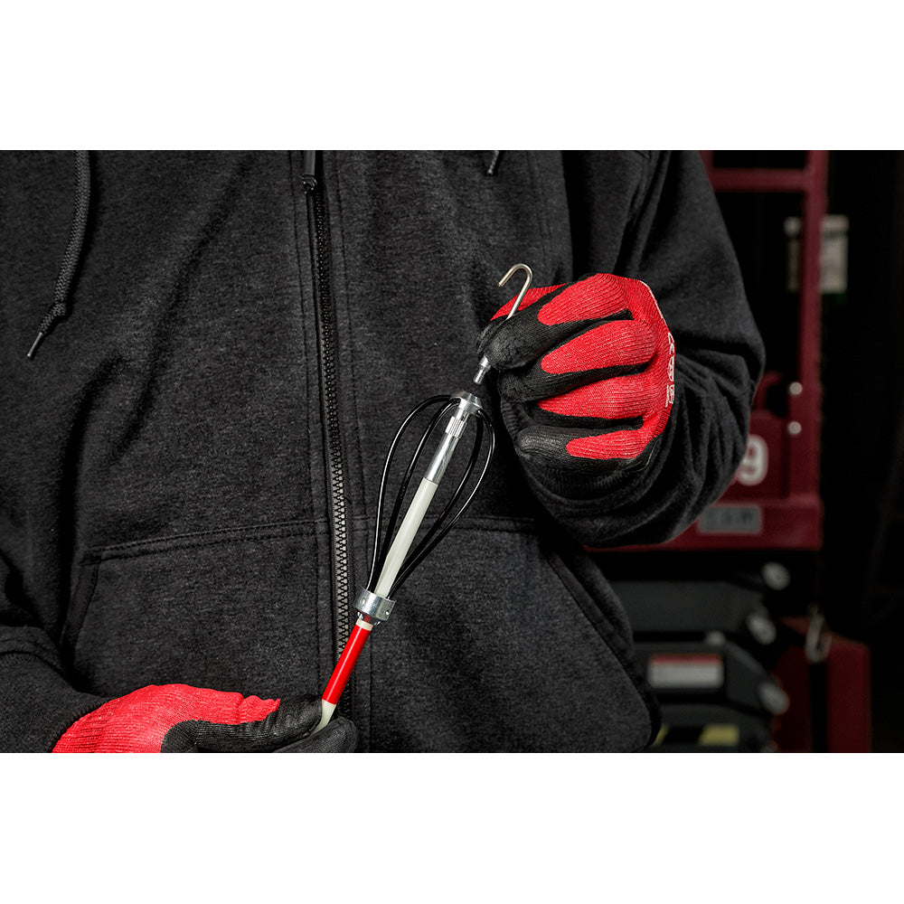 Person wearing red and black gloves holding a metal fish stick accessory with red handle and silver hook.