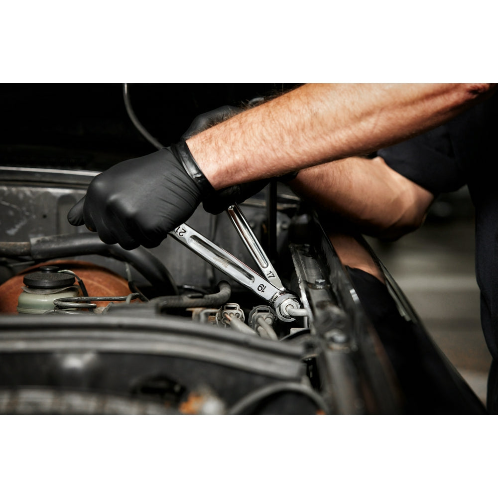 Chrome double-end flare nut wrench with 16mm and 18mm heads being used on engine components.