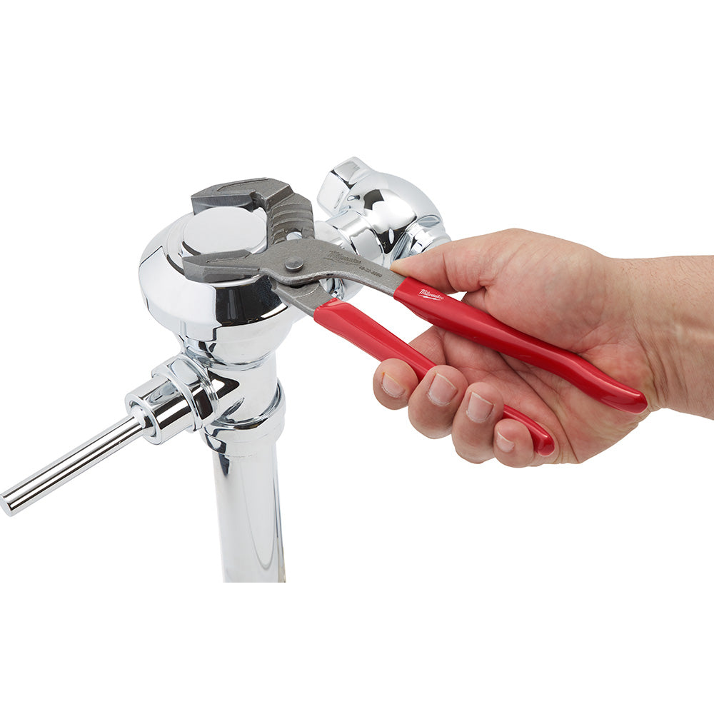 Red-handled 10" smooth jaw wrench gripping a chrome pipe fitting.