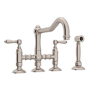 Satin nickel bridge kitchen faucet with curved spout, two handles, and separate side spray attachment.