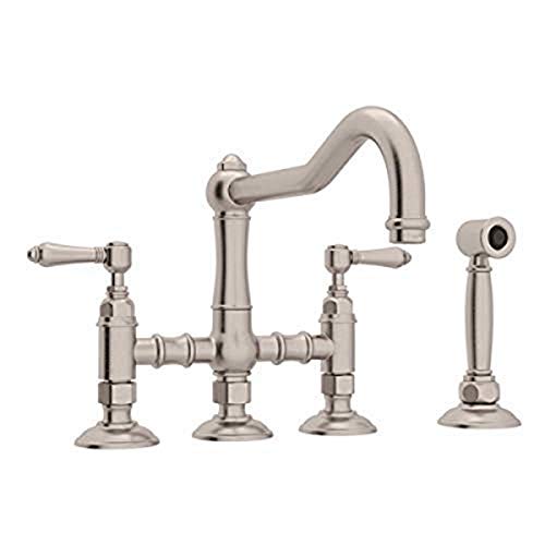 Satin nickel bridge kitchen faucet with curved spout, two handles, and separate side spray attachment.