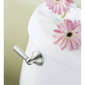 Brushed nickel lever handle mounted on white toilet tank with pink floral design.