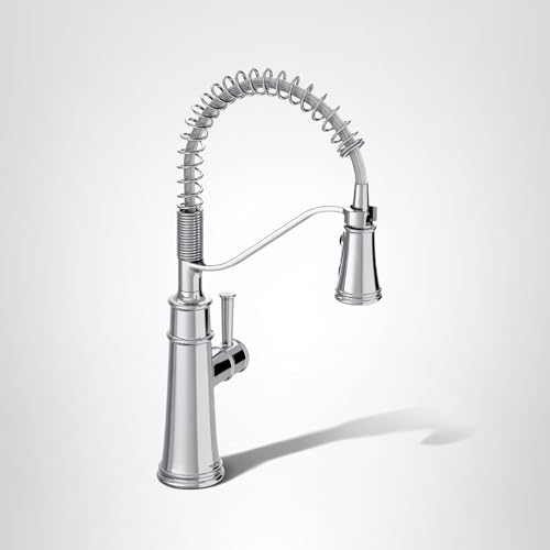 Chrome kitchen faucet with coiled pull-down spray head and single handle control.