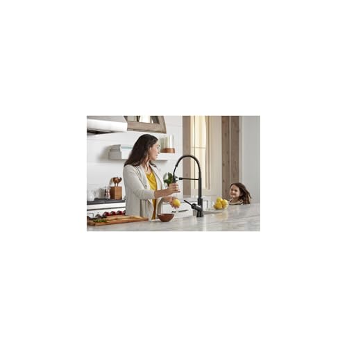 Matte black semi-pro kitchen faucet with pull-down spray head mounted on white countertop.