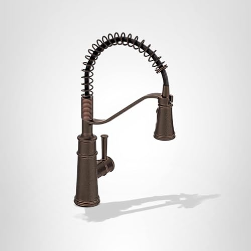 Oil rubbed bronze kitchen faucet with coiled spring spout and single lever handle.